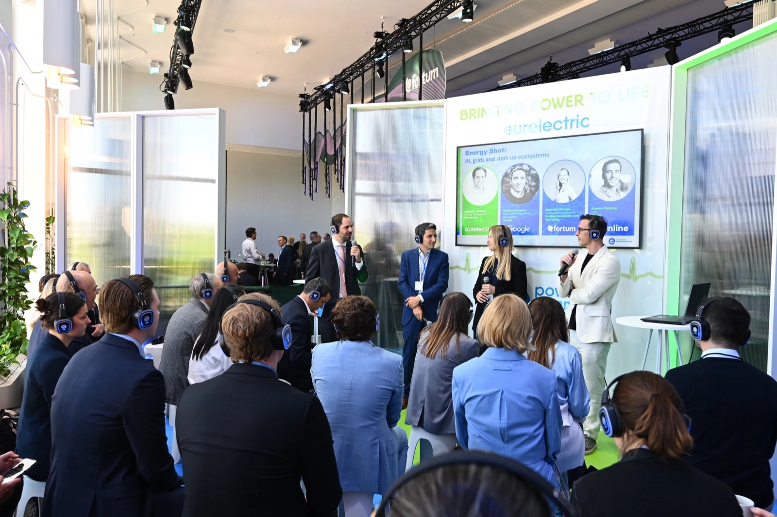 An Enline speaker on a Eurelectric panel titled "AI, grids and start-up ecosystems", alongside Eurelectric, Google and Fortum, before a seated audience wearing headsets